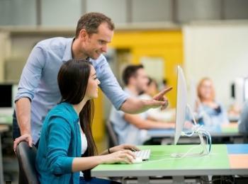Estudiante y docente en sala de cómputo