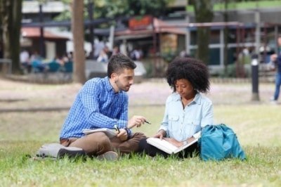 par de estudiantes leyendo en la zona verde